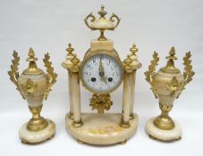 A French Empire style three piece alabaster and gilt metal clock garniture, the clock in a drum
