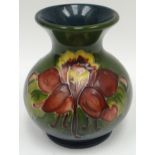 A Moorcroft green ground tube-lined floral onion-shaped vase, 3.5ins high (9cms)