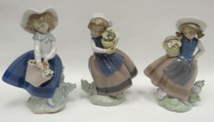 Three Lladro flower picking girl figures