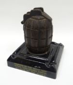 A First World War hand grenade mounted ash-tray inscribed 'MEMENTO OF THE GREAT WAR ACTUAL HAND