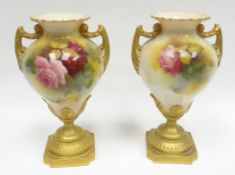 A pair of Royal Worcester pedestal vases, the blush bodies painted with pink and red roses amongst