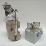 A Nao figure of a girl playing cello and a similar of two cats in a cradle