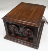 A wooden encased crystal radio set having Bakelite dials, hinged lid and with 'Brown' in applied