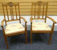 A pair of early-twentieth century Arts & Crafts style joined oak chairs with cushion seats