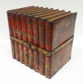 A Huntley & Palmer biscuit tin in the form of eight books bound together by a faux-leather strap,