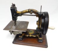A mid-Victorian English sewing machine 'The Challenge' by Joseph Harris, with gilt decoration to the