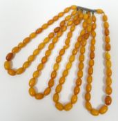 A four strand necklace of amber beads, 58gms