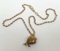 A 9ct yellow gold fish charm attached to a 9ct chain, 10gms