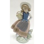 A Lladro figure of a girl picking flowers for her basket, 7ins high (18cms)
