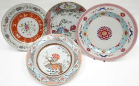 Three nineteenth century tin-glaze plates and a similar dish, all polychrome enamel decorated in the