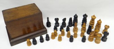 A nineteenth century wooden chess-piece set composed of nicely carved pale wood and ebony figures,