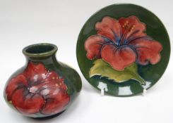 A Moorcroft green ground tube-lined circular dish, 4.5ins diam (11cms) and matching squat vase