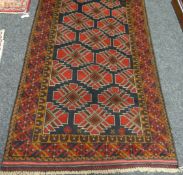 A hand-woven Afghan Balouchi tribal rug, 42 x 75ins (107 x 190cms)