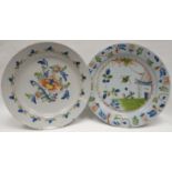 Two eighteenth century polychrome delft chargers, one with a spray of flowers to the interior and