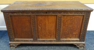 An early nineteenth century chest, with hinged plank-top lid and having lunette and floral carved