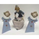 A pair of Nao standing clown children and a Nao seated lady with kittens