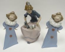 A pair of Nao standing clown children and a Nao seated lady with kittens