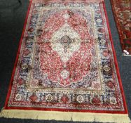 A small red ground Kashmir rug, 66 x 45ins (169 x 116cms)