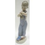 A Lladro figure of a boy in dungarees with hammer and toy truck, 8.75ins high (22cms)