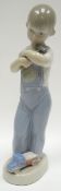 A Lladro figure of a boy in dungarees with hammer and toy truck, 8.75ins high (22cms)