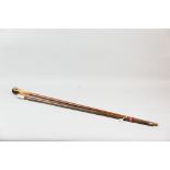 A wooden swagger stick with white metal top bearing the emblem for the Royal Fusiliers along with