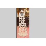 A Victorian cast iron hallstand with small oval mirror, five hat and coat hooks and umbrella and