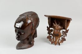 A carved coramandel head of an African woman, 23 cms high, along with an Austrian wall bracket of