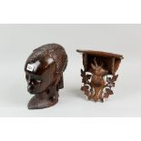 A carved coramandel head of an African woman, 23 cms high, along with an Austrian wall bracket of