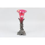 A cranberry single flute epergne on a leaf and floral relief cast metal stand, 31 cms high