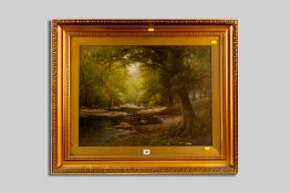 J W STAMPER oil on canvas - wooded river scene, signed and entitled label verso 'River Lledr above