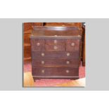 A Waring and Gillow mahogany compactum type chest having a narrow railback, two small narrow