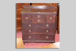 A Waring and Gillow mahogany compactum type chest having a narrow railback, two small narrow