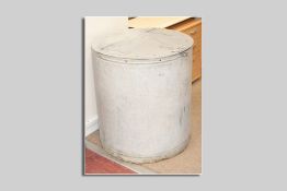 A large galvanized metal flour bin, a cylindrical bin with semi-circle lift-up lid on strap