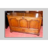 An early 19th Century oak mule chest having a twin plank moulded edge top over three fielded