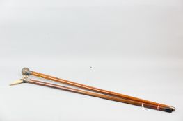Two malacca walking canes, one with boar's tusk handle, with silver and white metal mounts, 89