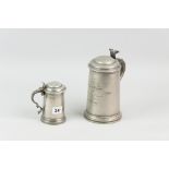 Two pewter glass bottomed lidded tankards, the larger with starburst cut ruby red glass bottom,