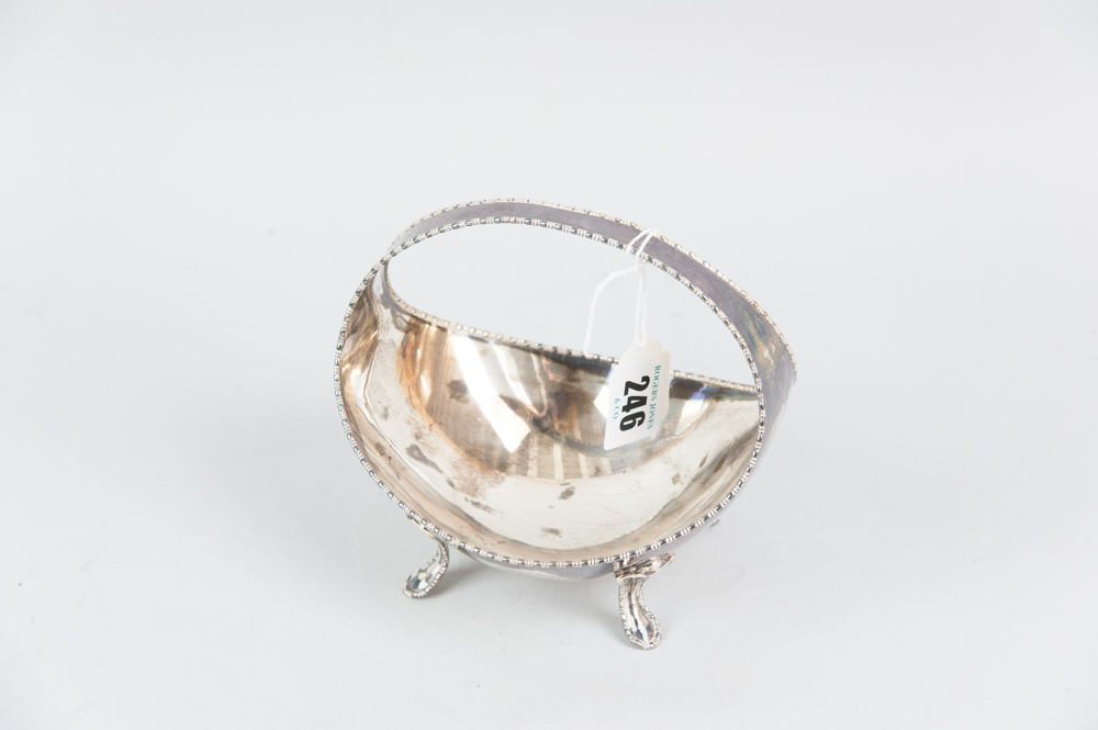 A boat shaped silver basket with centre incorporated handle and on four curved supports with