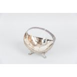 A boat shaped silver basket with centre incorporated handle and on four curved supports with