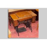 A Singer sewing machine oak table with cast iron treadle base, 78 x 90 cms