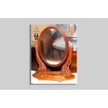 A Victorian mahogany swing toilet mirror having a bow front lidded base