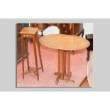 An oak oval topped Arts & Crafts style table with inlaid stringing to the top and simple carved