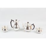A four piece silver tea and coffee service, each piece of circular plain form and with four shell