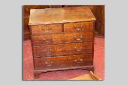 A 19th Century oak chest of three long and two short drawers with brass swan neck handles, 91 cms