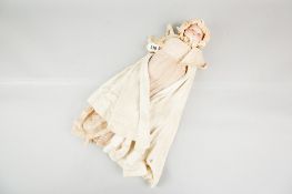 An Armand Marseille bisque headed baby doll with cloth body and legs, composition arms (chips and