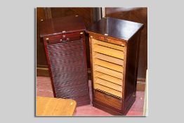 A good pair of late 19th Century stained oak tambour fronted music cabinets, each with nine light