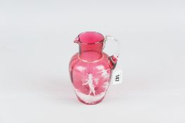 A cranberry glass jug with Mary Gregory decoration and with plain handle, 15cms high