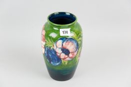 A Moorcroft pottery baluster shaped vase with surrounding tube line decorated band in the anemone