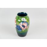 A Moorcroft pottery baluster shaped vase with surrounding tube line decorated band in the anemone