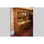 A good solid oak Art Nouveau mirror backed sideboard having an inverted step cornice, central mirror