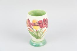 A Moorcroft pottery vase of ovoid form, tube lined decorated in the African lilies pattern on a